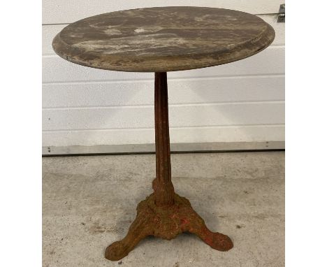 A vintage cast iron based pub table with wooden circular top. 3 footed pedestal base with floral decoration and scroll design