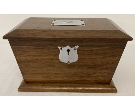 A vintage wooden sarcophagus shaped tea caddy with metal escutcheon &amp; plate to lid. With single internal compartment with