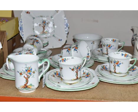 A SHELLEY 'CRABTREE' 11651 PATTERN TEA SET, comprising a milk jug, sugar bowl, square cake plate (cracked), nine cups (two ha