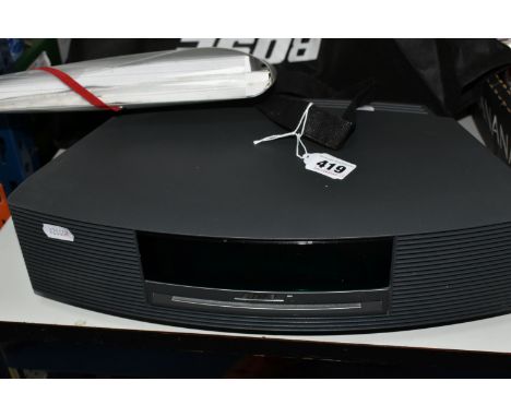 A BOSE WAVE MUSIC SYSTEM III comprising a Bose Wave Music System III unit with plug and remote control and original instructi
