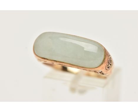 A 9CT GOLD JADE RING, designed as an elongated oval jade panel within a collet setting to the scrolling gallery, with 9ct hal