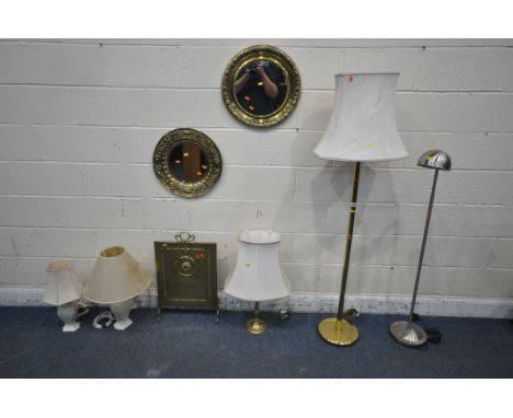 A BRASS TUBULAR STANDARD LAMP, another standard lamp, three table lamps, two circular pressed brass wall mirrors, along with 
