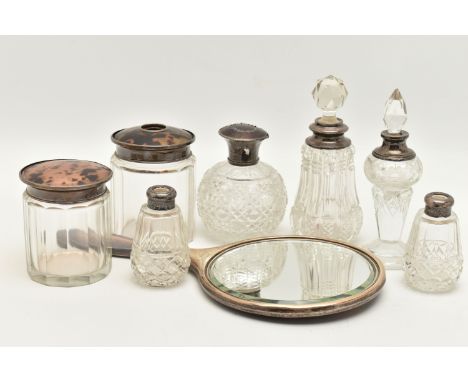 AN ASSORTMENT OF SILVER LIDDED VANITY JARS AN A MIRROR, to include a cut glass scent bottle with a silver and tortoise shell 