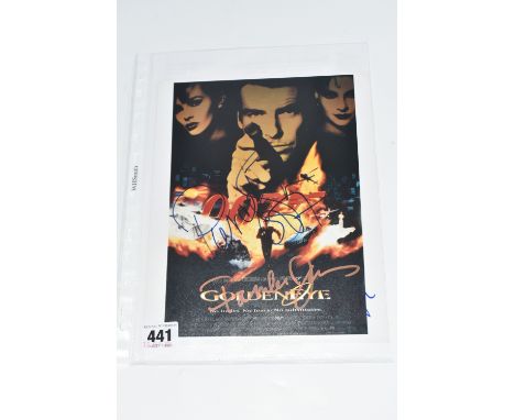 A SIGNED 10 x 8 COLOUR PROMO PHOTOGRAPH DEPICTING THE ORIGINAL MOVIE POSTER 'GOLDENEYE', signed by Pierce Brosnan, Famke Jans