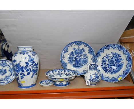 A GROUP OF BLUE AND WHITE DELFT WARE CHARGERS AND VASE, comprising a floral design vase, height 26cm, two chargers, diameter 