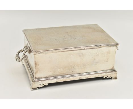 A GEORGE V SILVER CIGAR BOX, rectangular form, raised on four bracket feet, two knopped handles to the sides, engraved person
