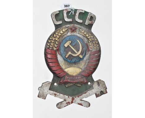 A CAST IRON SOVIET TRAIN CARRIAGE INSIGNIA marked CCCP over a hammer and sickle super-imposed on a stylized globe, beneath a 