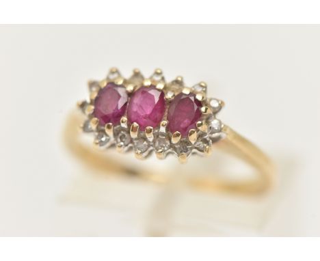 A 9CT GOLD RUBY AND DIAMOND RING, designed as three oval cut rubies within a single cut diamond surround, 9ct hallmark, ring 
