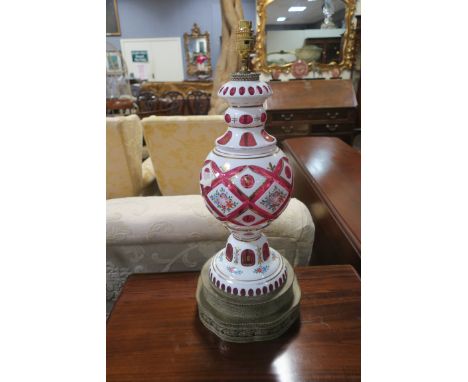 A FINE PAIR OF CONTINENTAL RUBY GLASS AND OPALINE GLASS TABLE LAMPS, each of baluster form decorated with floral panels above