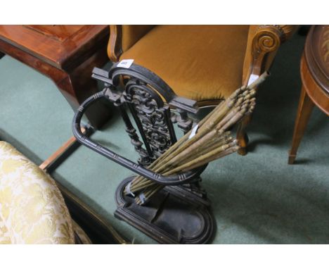 A CAST IRON STICK STAND together with part set of brass stair rods and fender (3)