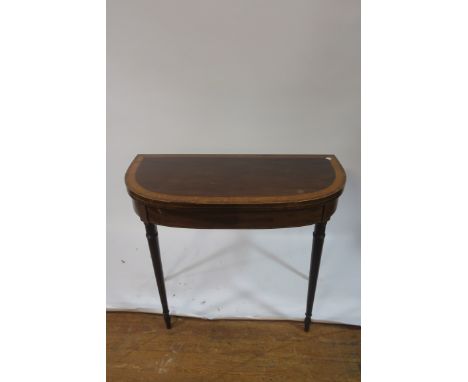 A 19th CENTURY MAHOGANY AND SATINWOOD CROSSBANDED FOLD OVER CARD TABLE, of demi lune outline, the hinged top containing a bai