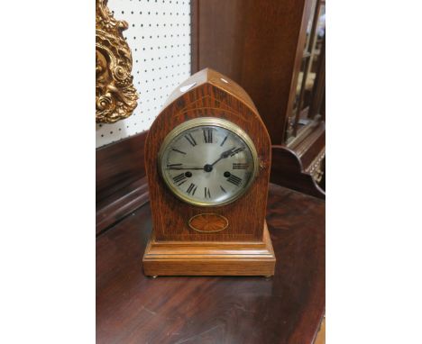 AN EARLY 20th CENTURY MAHOGANY AND MARQUETRY INLAID MANTEL CLOCK, the domed shaped case above a silvered dial with black roma