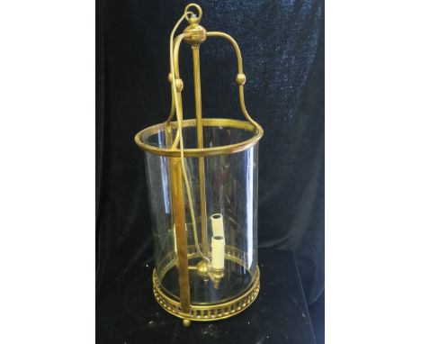 A BRASS AND GLASS THREE LIGHT HALL LANTERN, of cylindrical form with pierced circlet.