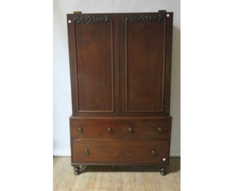 A 19th CENTURY MAHOGANY LINEN CUPBOARD, the panelled doors with scrolled mounts opening to reveal a sliding shelved interior 