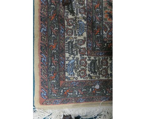 A WOOL RUG the cream light pink and grey ground with central panel within conforming borders 208cm X 122cm 