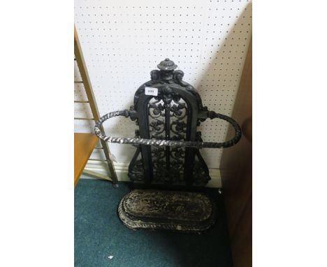 A VICTORIAN CAST IRON STICK STAND with pierced back plate above an oval base with drip pan