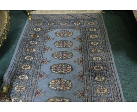 A WOOL RUNNER the light blue ground with central pelmets within a conforming border 187cm X 63cm