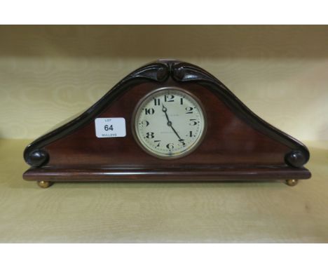 A MAHOGANY FRAMED MANTLE CLOCK early 20th century by Grant and Son, South Shields in a shaped frame with foliate scrolled bor