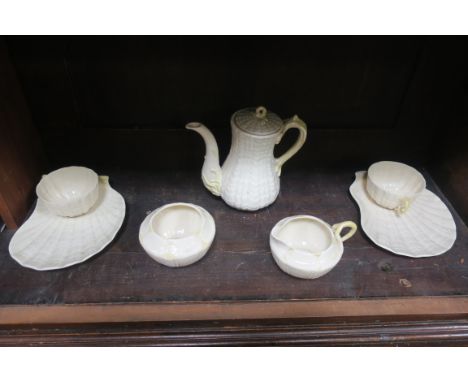 A MODERN BELEEK TRIDACNA PATTERN TEASET, comprising of six teacups on fitted shell shaped serving saucers,  a teapot (damaged