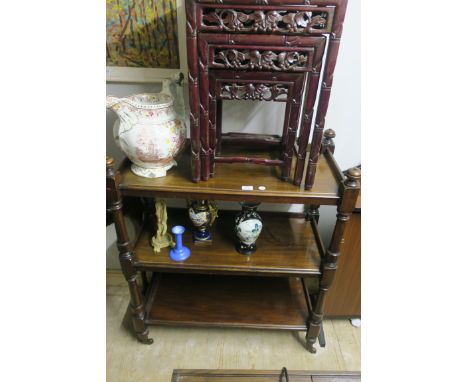 A VICTORIAN MAHOGANY THREE TIER DUMB WAITER each moulded shelf joined by baluster support on brass casters 106cm X 90cm X 40c