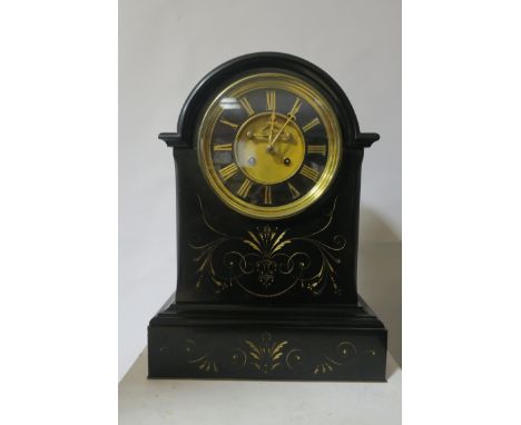 A BLACK MARBLE CLOCK, BY MILLER & SON LONDON, the arched top above a black dial with Roman numerals and brass bezel engraved 