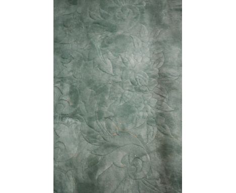 A GOOD CHINESE WOOL RUG, the plain light green ground with floral decoration,375cms x 280cms.