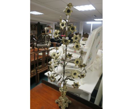 A BRASS CANDELABRA with flower head and foliate decoration raised on a rococo base 120cm (h)
