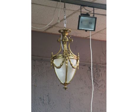 A CONTINENTAL GILT BRASS FROSTED AND ENGRAVED GLASS CENTRE LIGHT, hung with ribbon tied swags.