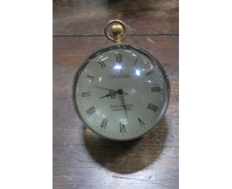 A BRASS AND GLASS DESK CLOCK, the white dial roman numerials inscribed Omega 