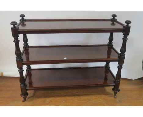 A VERY FINE WILLIAM IV MAHOGANY THREE TIER DUMB WAITER, each moulded shelf with three quarter gallery, raised on baluster sup