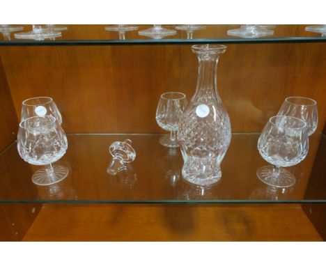 A SET OF FIVE WATERFORD CUT GLASS BRANDY BALLOONS of typical form with diamond cut bowl on circluar foot together with a deca