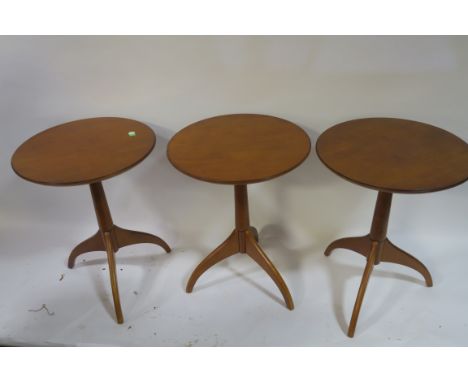 A SET OF THREE CHERRY WOOD OCCASIONAL TABLE, each of circular outline raised on tripod support, 66cms x 50cms.