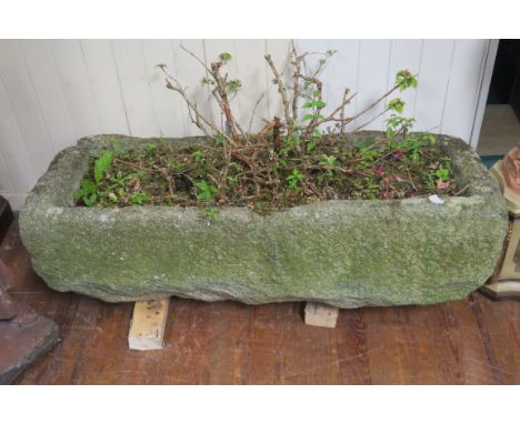 A GRANITE TROUGH, of rectangular outline,31cms x 120cms x 50cms.