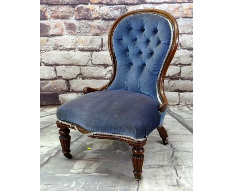 EARLY VICTORIAN WALNUT NURSING CHAIR with button upholstered balloon back and gadrooned tapering legs, brass cappings and cer