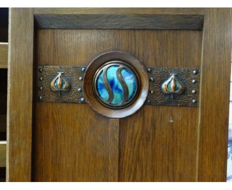 ARTS & CRAFTS OAK PART WARDROBE, possibly by Shapland & Petter or Liberty, the panelled oak door with hammered copper and gla