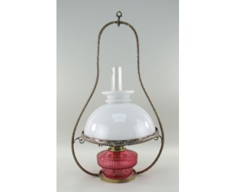 CRANBERRY GLASS &amp; BRASS HANGING OIL LAMP with opaque glass shade and clear glass funnel, 63cms high