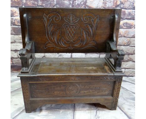 REPRODUCTION OAK MONK'S BENCH, lion carved arms and engraved shield top, 107cms wide