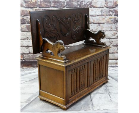REPRODUCTION OAK MONK'S BENCH with lion arm supports, shield carved top and linen fold front, 106cms wide