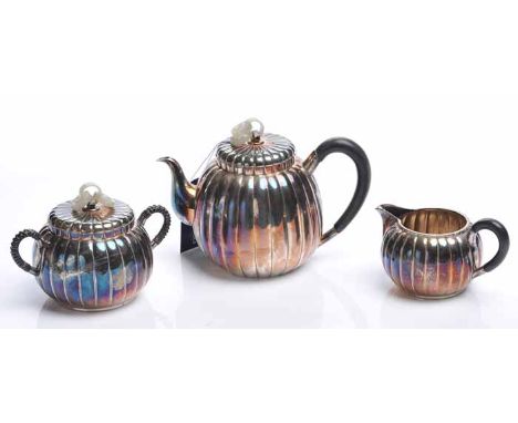 CHINESE SILVER THREE PIECE TEA SERVICE 
comprising tea pot, sugar and cream, each of lobed form, the tea pot and cream with w