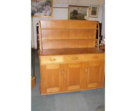 Ercol dresser of small proportion, incorporating two shelf plate rack, three apron drawers, double concertina action cupboard