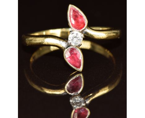 An 18ct gold ring set with a diamond of approximately 0.1ct and two pear cut rubies, 4.3g, size P