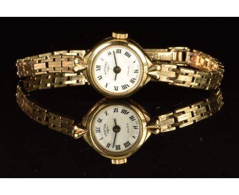 Rotary 9ct gold ladies wristwatch with black hands and Roman numerals, white dial and 21 jewel movement, on 9ct gold bracelet