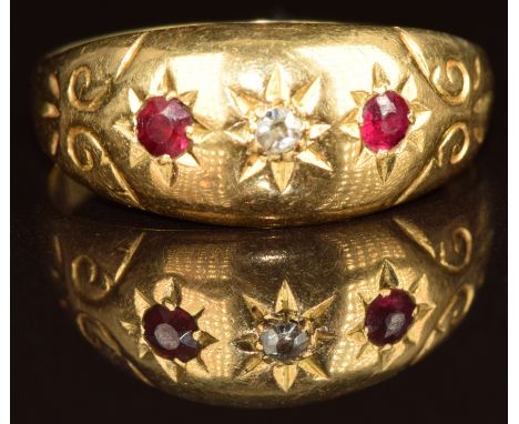 A c1900 18ct gold ring set with a ruby and two diamonds in star settings, 3.1g, size Q