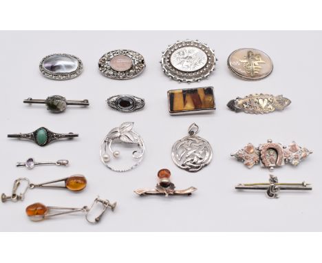 A collection of silver brooches including Victorian with applied gold horseshoe and floral decoration, Edwardian with swallow