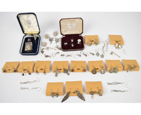Twenty five pairs of silver earrings, silver perfume bottle and two silver studs set with mother of pearl&nbsp;