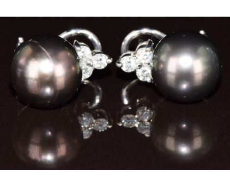 A pair of 14k white gold earrings each set with a Tahitian pearl and three diamonds, 8.8g&nbsp;