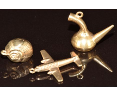 An 18ct gold charm in the form of a pipe (1.7g), and two 9ct gold charms, one in the form of a plane and the other a shell (1