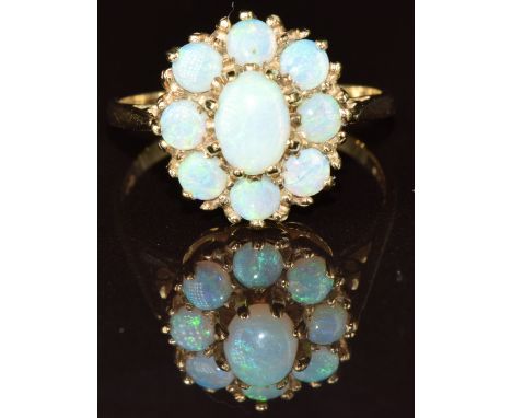 A 9ct gold ring set with a cluster of opals, 3.4g, size R