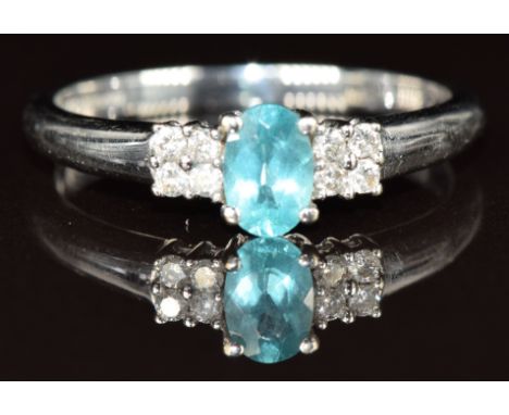 A 9k white gold ring set with an oval cut apatite and diamonds, 2.5g, size Q
