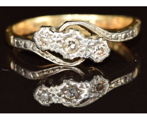 An 18ct gold ring set with three diamonds in a platinum twist setting, 2.8g, size L